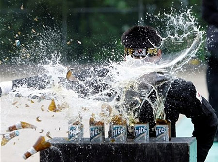 A South Korean special police force personnel breaks five bottles of beer by hand during an anti-terrorism drill.
